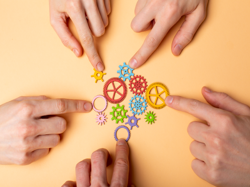 Gears on a table representing different departments in a company. Operational Efficiency