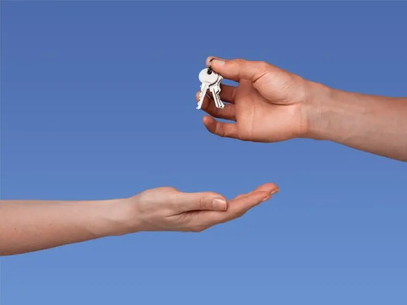 Handing off keys from one person to another.