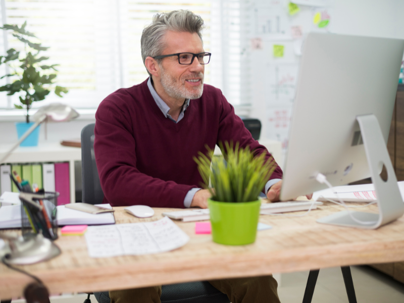 Print professional working on sustainability metrics in a bright, modern office