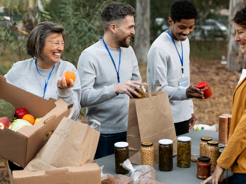 Volunteers engaging in a community food drive as part of a CSR initiative
