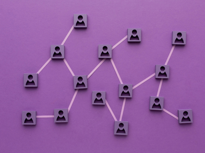 Illustration of interconnected icons representing people, symbolizing organizational structure and teamwork.