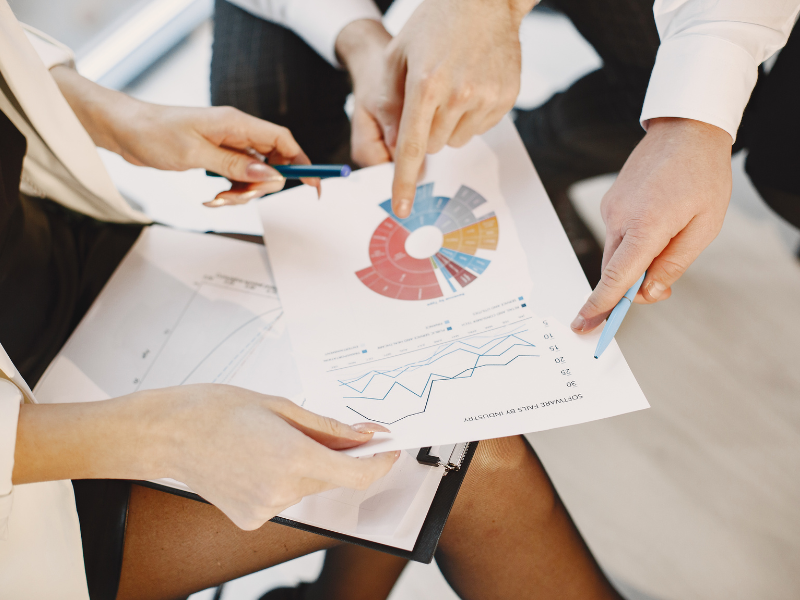 Team reviewing charts and performance data together, representing analysis and decision-making in advanced market segmentation.