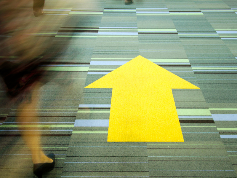 exit readiness should not be a fire drill Large yellow arrow on a floor pointing forward, symbolizing strategic direction, business preparedness, and exit readiness planning.