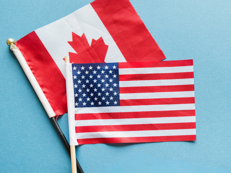 Canadian and U.S. flags on a blue background, representing cross-border acquisitions for Canadian printers