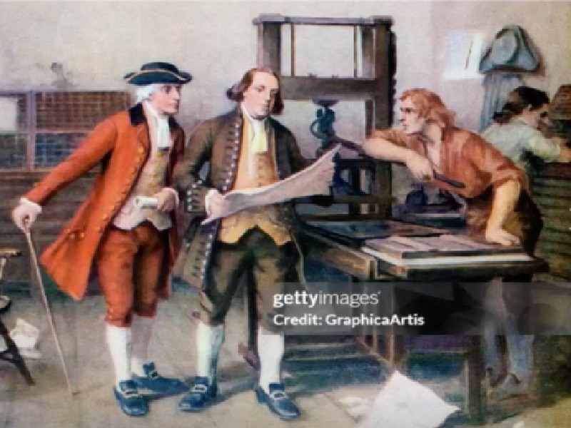 3 men working on a printing press from the 1700s.