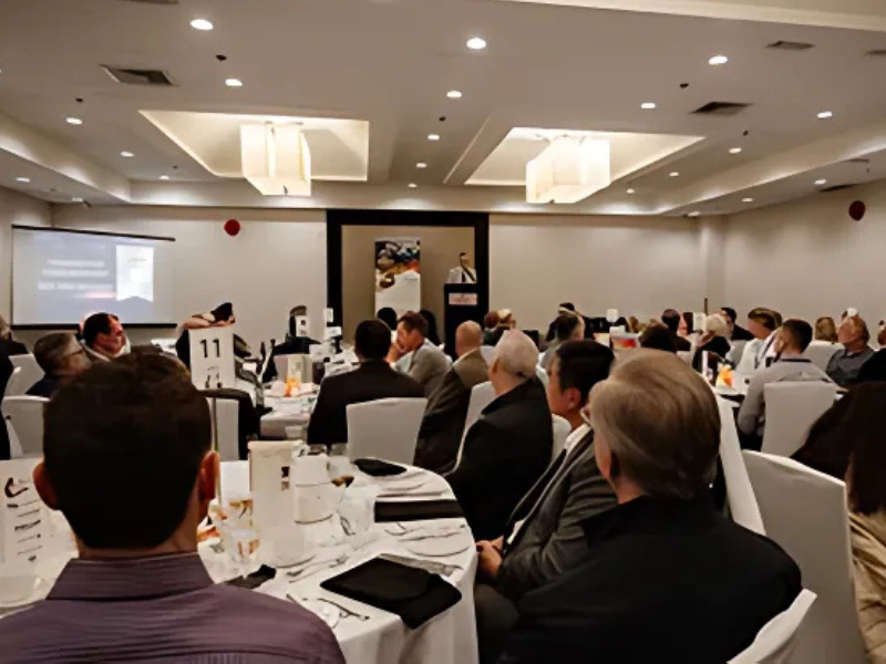 A banquet hall filled with attendees at the MPIA Awards Gala, with a speaker addressing the audience from a podium.