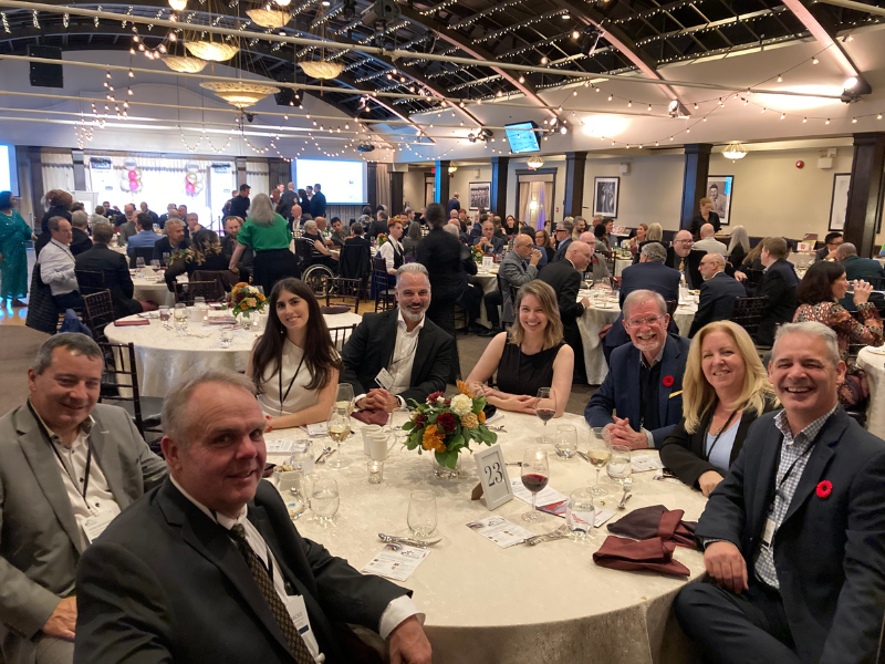 The CFR team seated together at a table during the Canadian Printing Awards event, with a lively, decorated venue in the background.